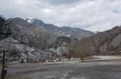 Rocky landscape with mountains in the background.